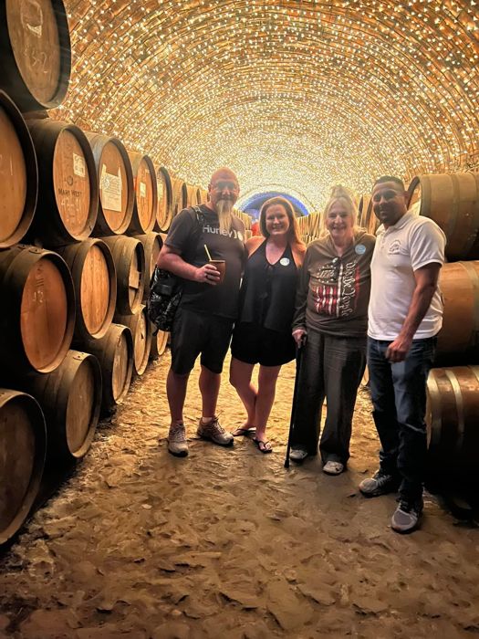 Tour group in a barrel-lined tequila cellar