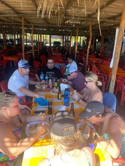 Group sharing a meal at a large open-air restaurant