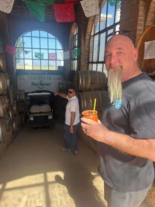Guest with a cantarito drink at a distillery