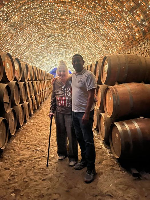 Couple standing in a barrel cellar