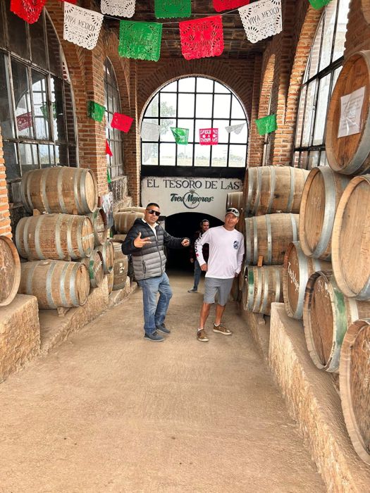 Visitors walking through a barrel cellar