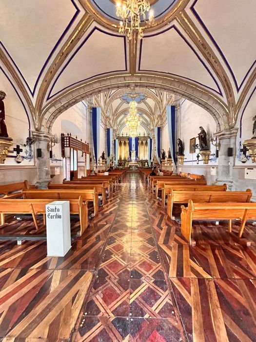 Ornate church interior with chandeliers