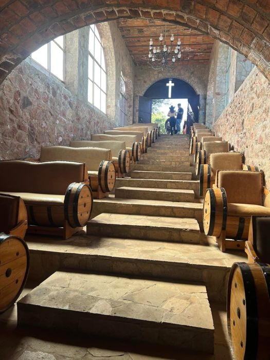 Arched cellar with rows of barrels