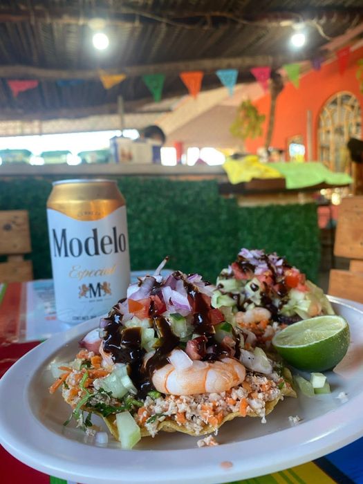 Seafood tostada with lime and a cold beer
